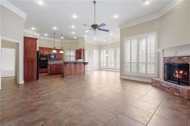 kitchen with a brick fireplace, black microwave, ornamental molding, a kitchen island, and pendant lighting