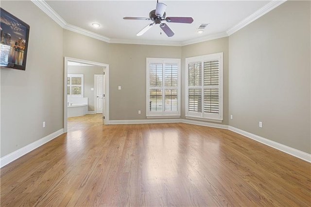 empty room featuring ornamental molding, ceiling fan, and light wood-type flooring