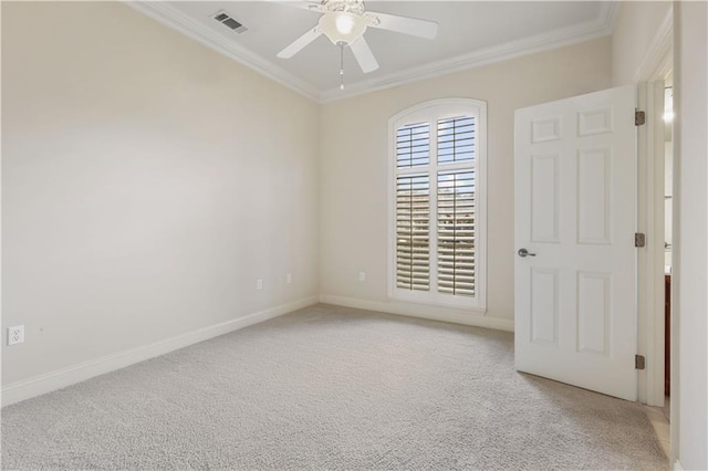 carpeted empty room with crown molding and ceiling fan