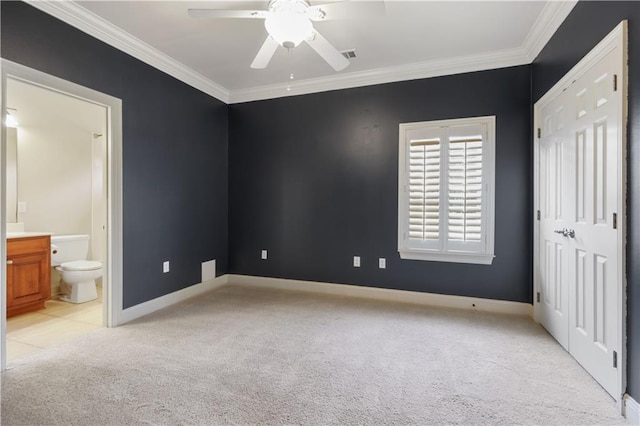 unfurnished bedroom with connected bathroom, crown molding, light colored carpet, and ceiling fan