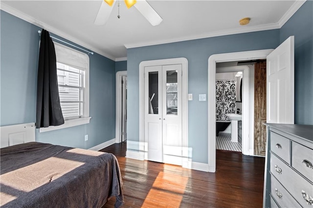 bedroom with dark wood-style floors, baseboards, and ornamental molding