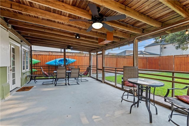 view of patio with outdoor dining space, a fenced backyard, and ceiling fan