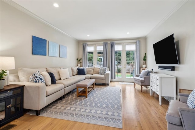 living room featuring crown molding and light wood-type flooring