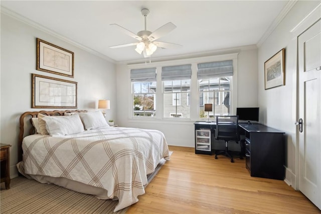 bedroom with crown molding, ceiling fan, wine cooler, and light wood-type flooring