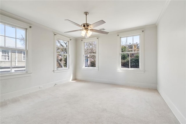 carpeted empty room with ornamental molding and ceiling fan