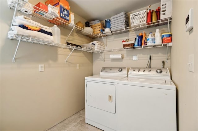 laundry room with washing machine and dryer and light tile patterned flooring