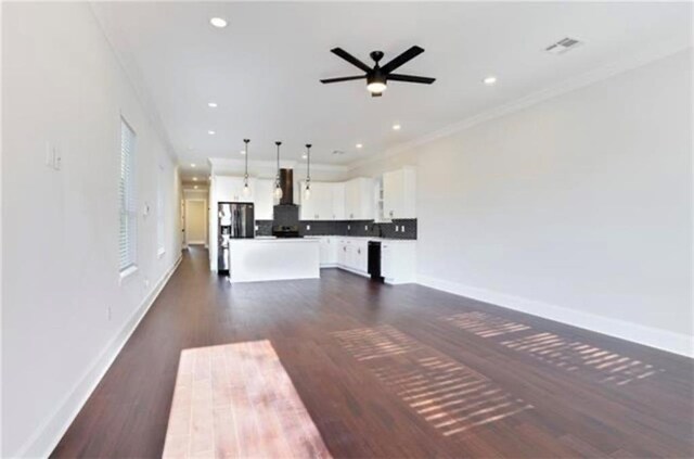 unfurnished living room featuring crown molding, dark wood-type flooring, and ceiling fan