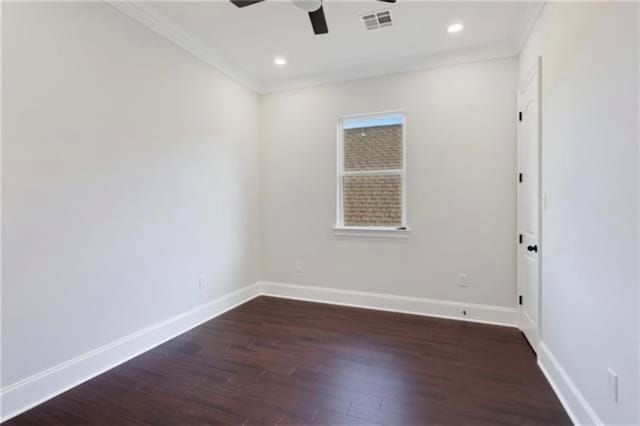 spare room featuring dark wood-type flooring, ornamental molding, and ceiling fan