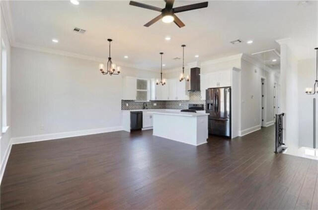 kitchen featuring a center island, stainless steel refrigerator with ice dispenser, white cabinets, decorative light fixtures, and wall chimney exhaust hood