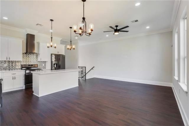 kitchen with white cabinetry, a center island, pendant lighting, stainless steel appliances, and wall chimney range hood