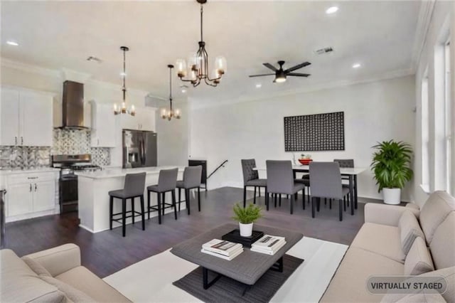 living room featuring ornamental molding, dark wood-type flooring, and a notable chandelier