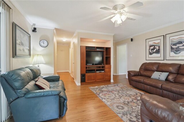 living room with hardwood / wood-style flooring, crown molding, and ceiling fan