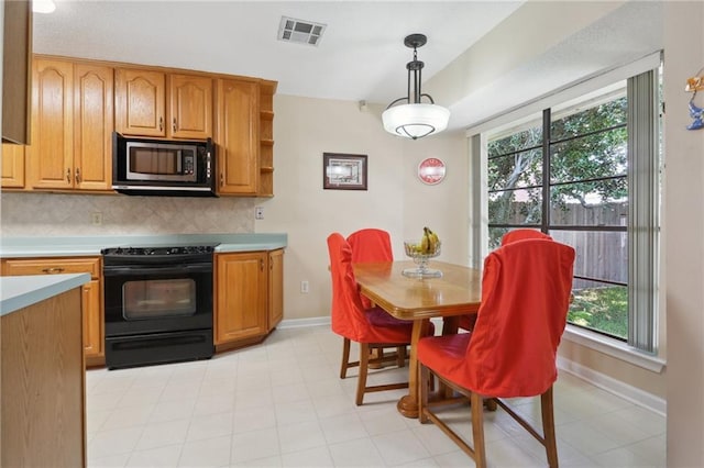 kitchen with hanging light fixtures, decorative backsplash, and black appliances