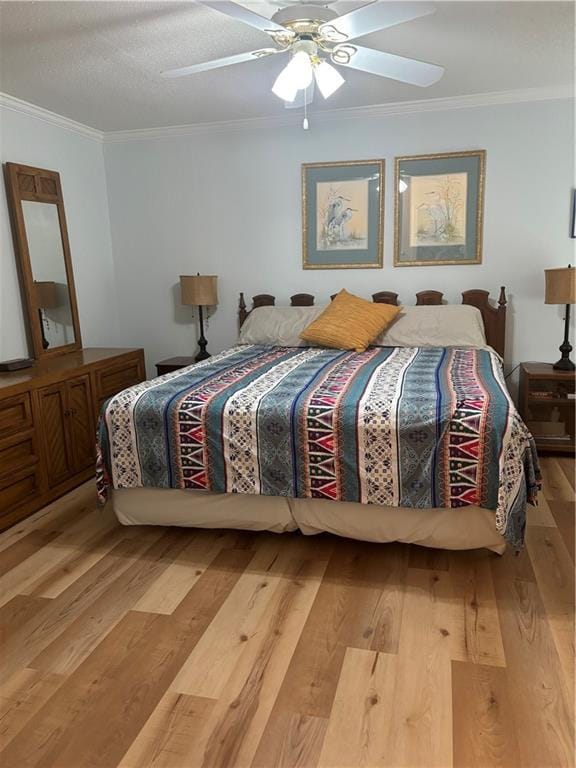 bedroom featuring wood-type flooring, ornamental molding, and ceiling fan