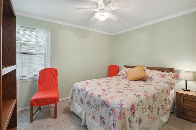 carpeted bedroom with ceiling fan and ornamental molding