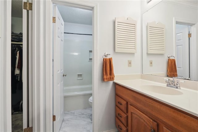 bathroom with vanity, crown molding, toilet, and a textured ceiling