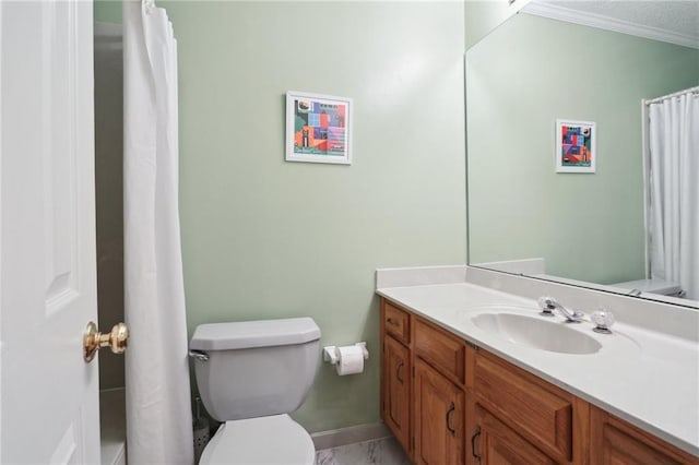 bathroom with vanity, ornamental molding, and toilet