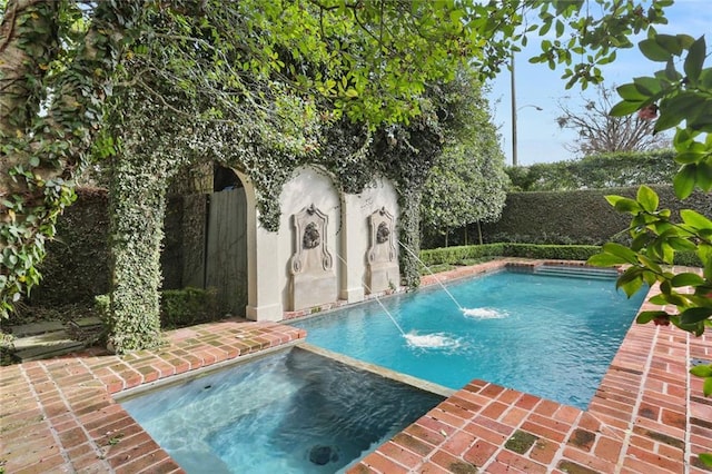 view of pool featuring an in ground hot tub