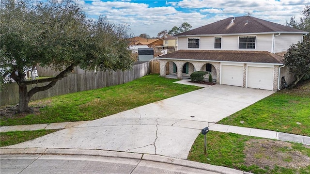 view of front property featuring a garage and a front yard