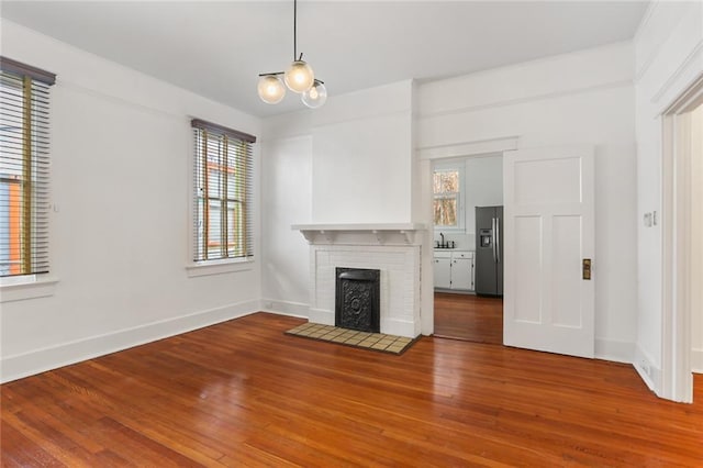 unfurnished living room featuring a fireplace and wood-type flooring