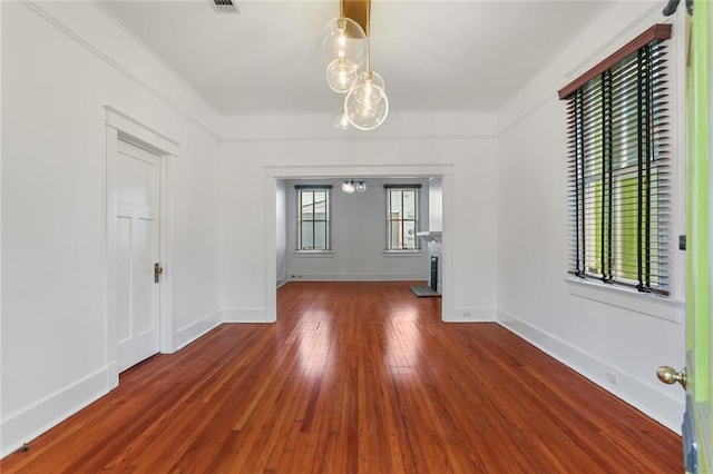 unfurnished room with dark hardwood / wood-style flooring and ornamental molding