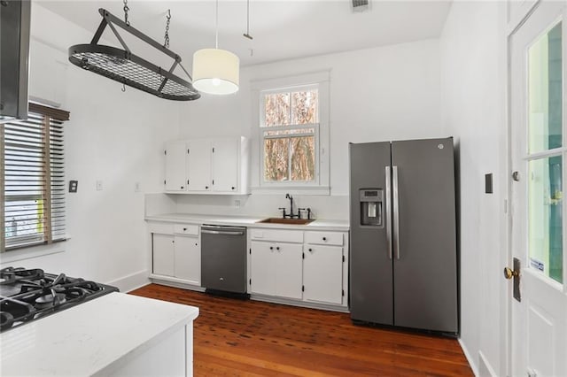 kitchen featuring dark wood-type flooring, appliances with stainless steel finishes, sink, and white cabinets