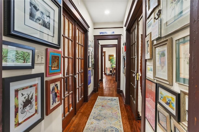 hallway with dark hardwood / wood-style flooring