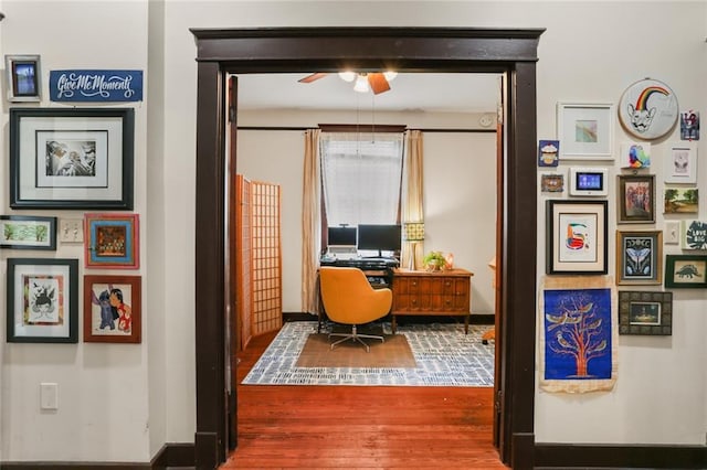 home office with hardwood / wood-style floors and ceiling fan