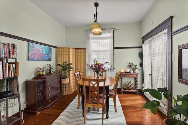 dining space with dark hardwood / wood-style floors