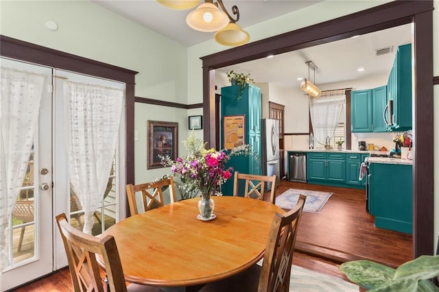 dining area featuring sink, light hardwood / wood-style floors, and french doors