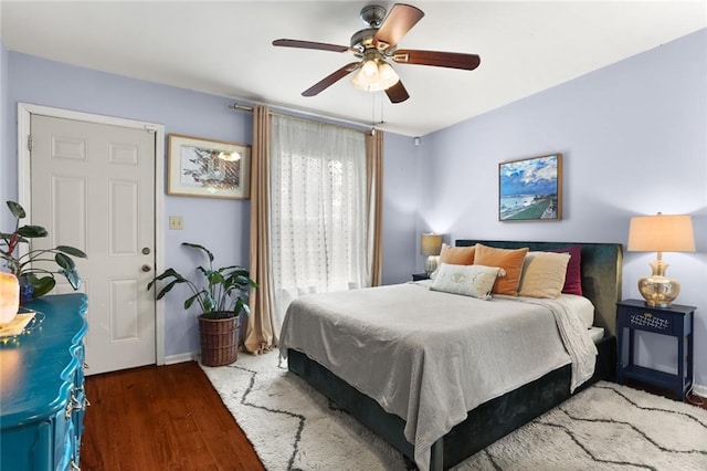 bedroom with ceiling fan and dark hardwood / wood-style flooring