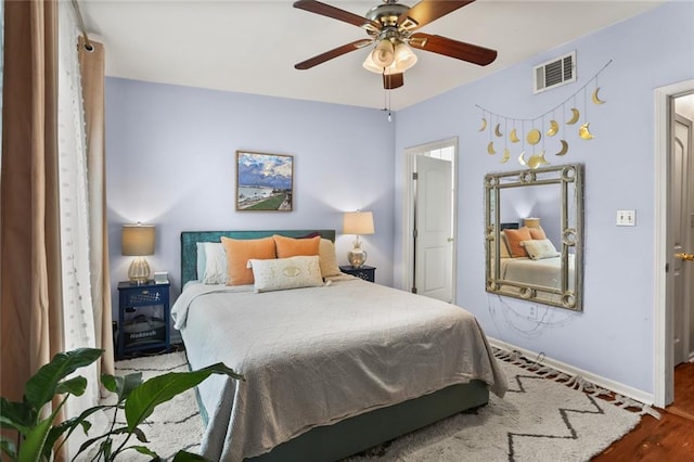 bedroom with wood-type flooring and ceiling fan