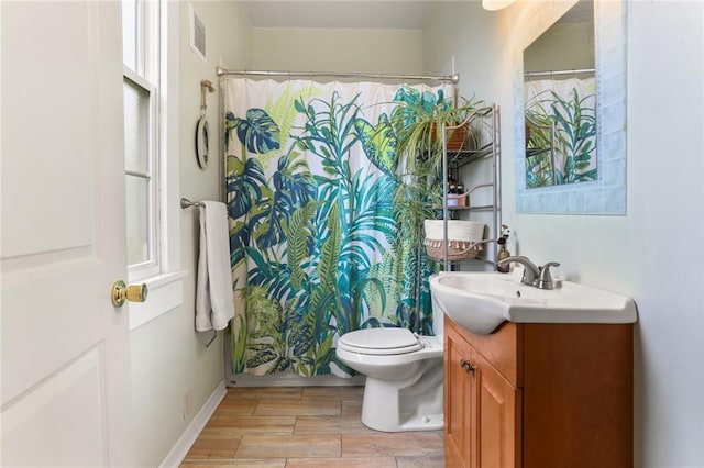 bathroom featuring vanity, toilet, and a shower with shower curtain