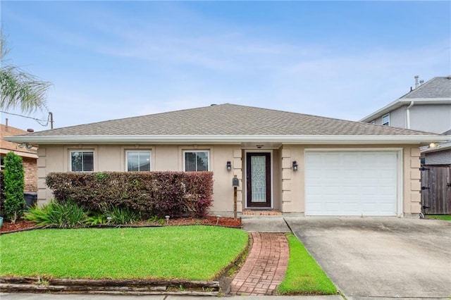 ranch-style house featuring a garage and a front lawn