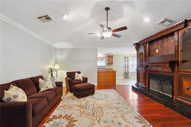 living room featuring ornamental molding, dark hardwood / wood-style floors, and ceiling fan