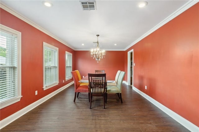 dining room with dark hardwood / wood-style flooring, a notable chandelier, and crown molding