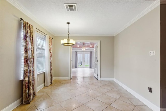 unfurnished dining area featuring crown molding, french doors, and a textured ceiling