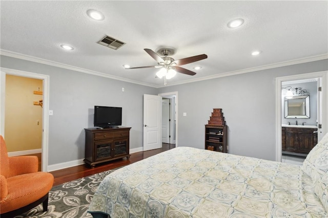 bedroom with crown molding, dark hardwood / wood-style floors, and sink