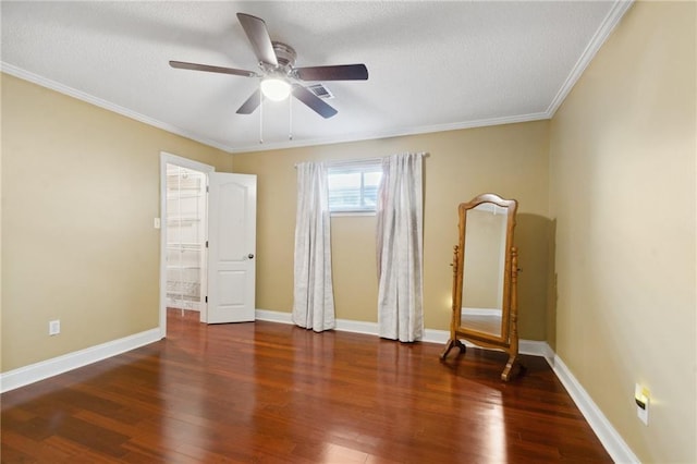 interior space featuring crown molding, ceiling fan, and dark hardwood / wood-style flooring