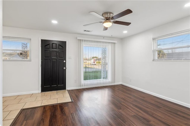 foyer featuring wood-type flooring, plenty of natural light, and ceiling fan