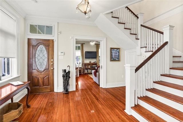 entryway with crown molding and hardwood / wood-style floors