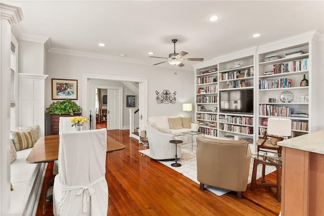 sitting room featuring crown molding, built in features, ceiling fan, and dark hardwood / wood-style flooring