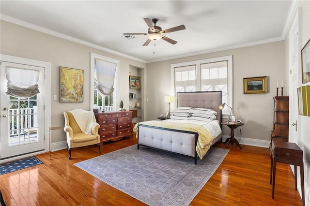 bedroom with crown molding, access to exterior, hardwood / wood-style flooring, and ceiling fan