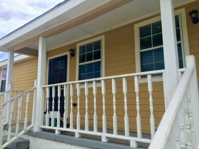 view of exterior entry featuring a porch