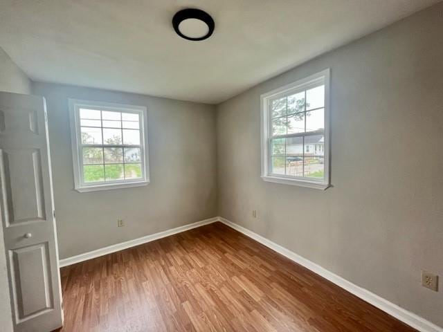 unfurnished bedroom featuring baseboards and wood finished floors