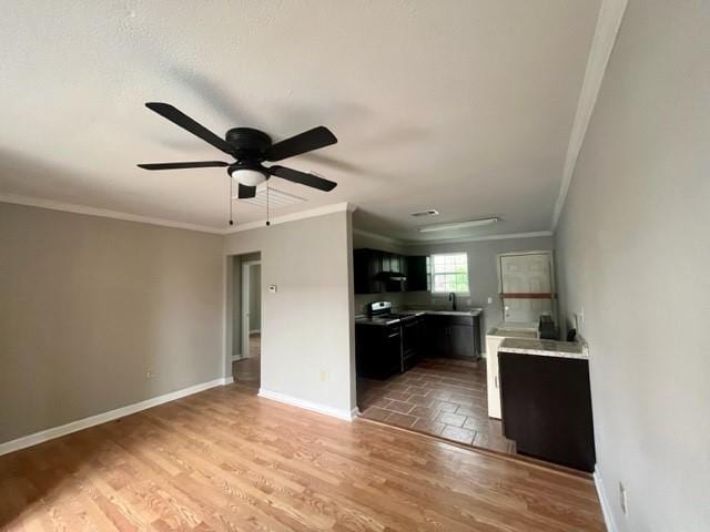 interior space featuring black / electric stove, dark cabinets, baseboards, ornamental molding, and light wood-type flooring