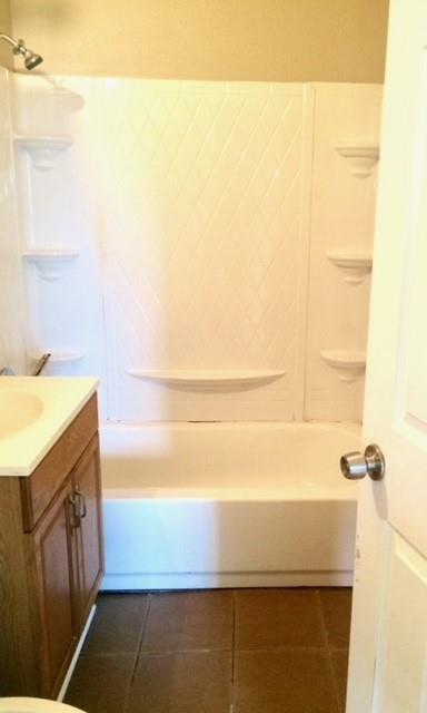 bathroom with shower / bathtub combination, vanity, and tile patterned floors