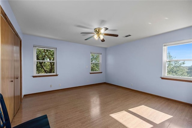 spare room with ceiling fan and light wood-type flooring