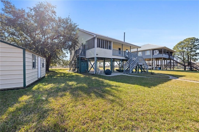 back of property with a yard and a sunroom