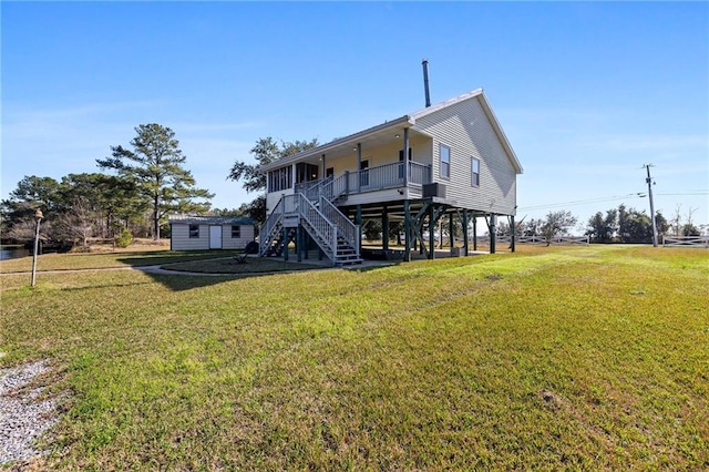 back of house featuring an outdoor structure and a yard